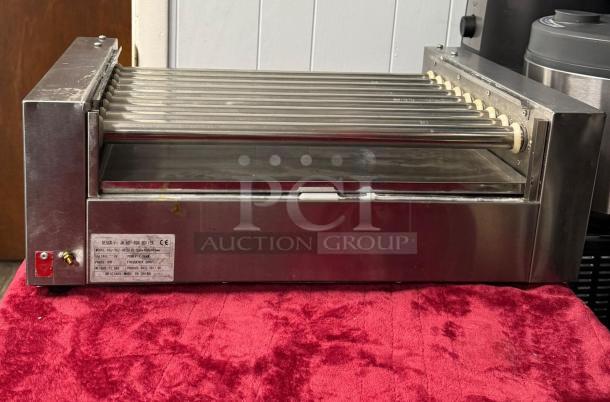 Hot Dog Roller Grill XCJ-9CZ-US, slanted top, 120v, manual controls, stainless steel, used, label with specifications visible.