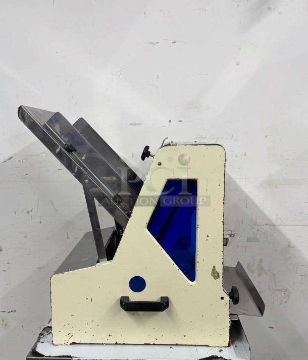 Omcan USA countertop bread slicer, model 302-5/18, 1/4 HP, 110V. Features steel frame, visible wear, and manual controls.