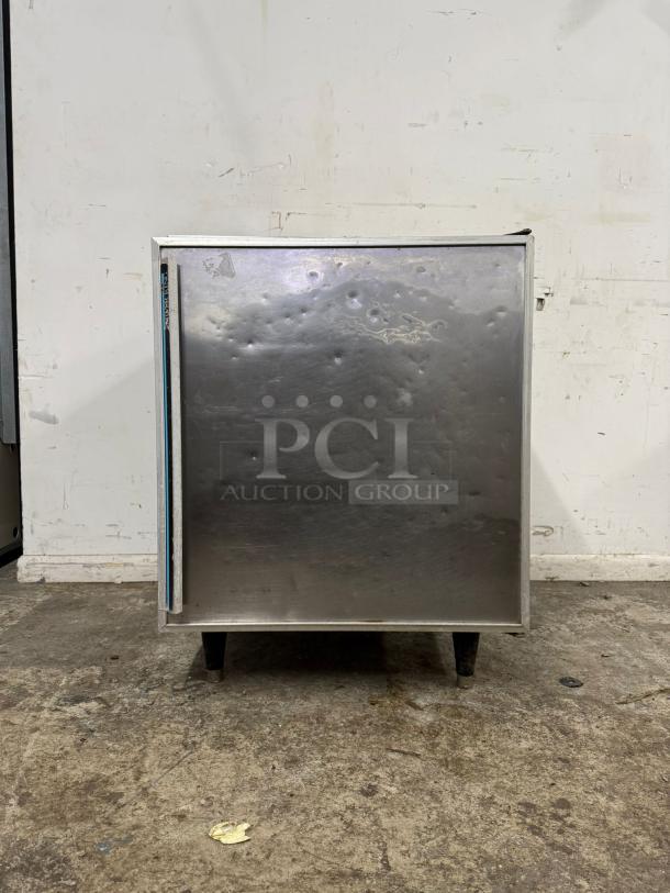 Silver King SKTTR7 undercounter refrigerator, stainless steel, visible dents, front view, on auction, brand label on side.