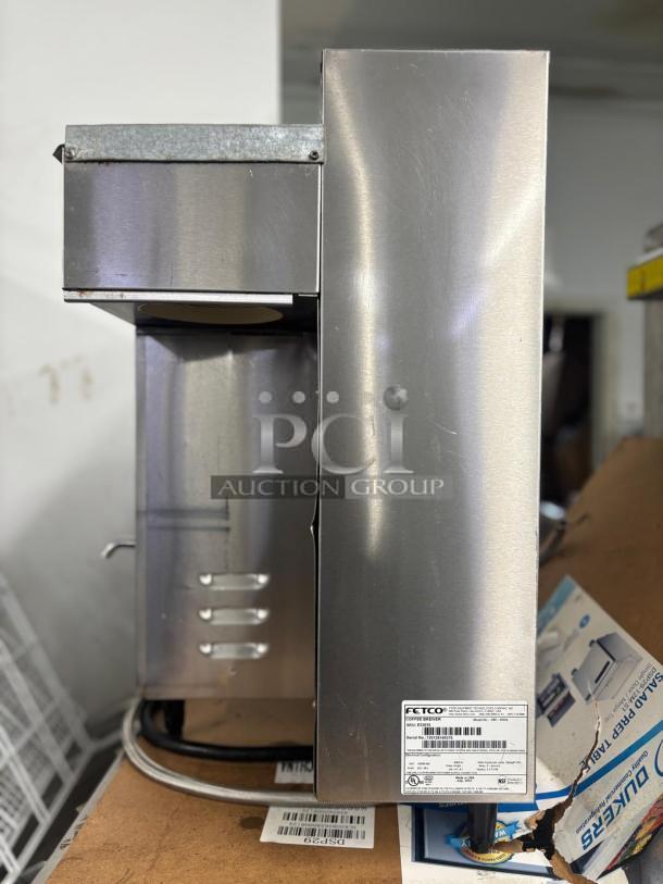 Fetco Coffee Brewer E32015, stainless steel, showing model label and auction group branding, in good condition.