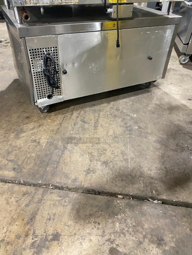Commercial stainless steel 2-drawer refrigerated low boy/chef base, on casters. Features durable design, visible power cord.
