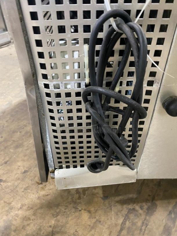 Commercial stainless steel 2-drawer refrigerated low boy/chef base on casters, shown with vented side panel and power cord.