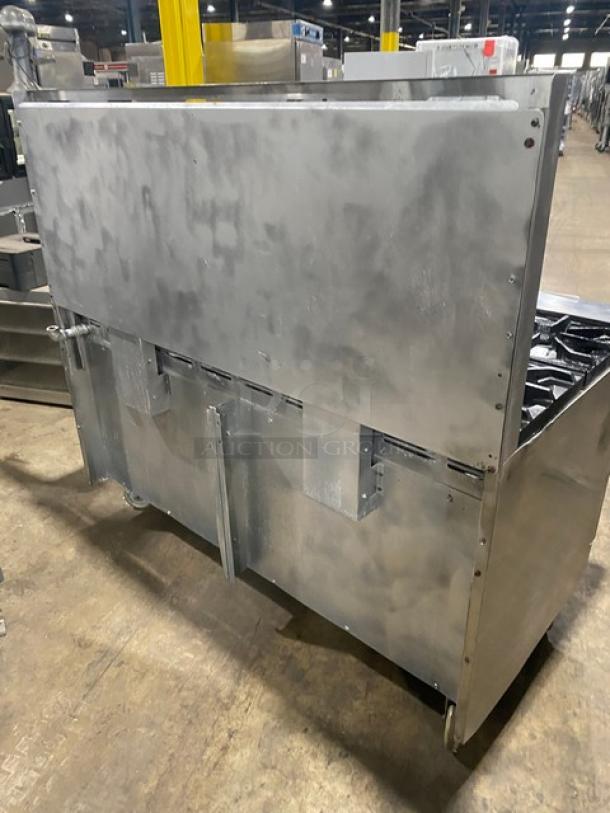 American Range commercial stainless steel 10-burner range with double oven, backsplash, wired racks, and casters.