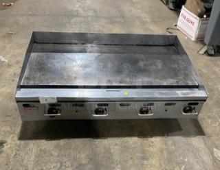 Wolf commercial stainless steel flat griddle, natural gas powered, with back and side splash, on legs, used condition.