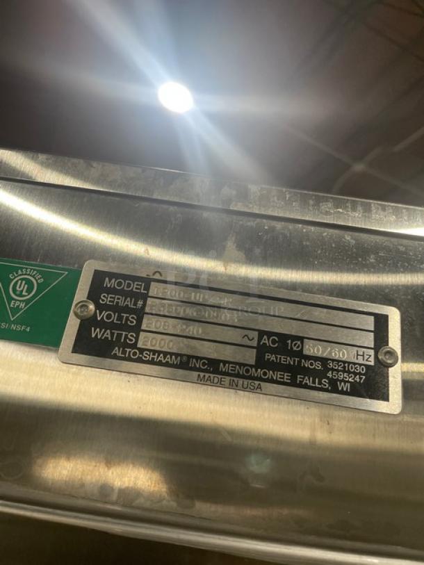 Alto-Shaam 1200-UP/SR commercial stainless steel holding cabinet label, showing model, serial number, voltage, and wattage details.