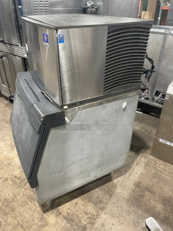 Manitowoc SD0303W stainless steel ice maker with storage bin, lift-style bin door, water-cooled, electric, on legs, 115V, used.