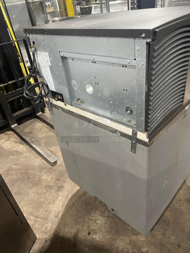 Manitowoc SD0303W stainless steel ice machine with lift-style bin door, electric-powered, water-cooled, on legs, 115V, 1 phase.