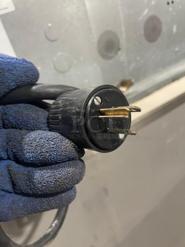 Close-up of power plug for Manitowoc SD0303W ice machine, showcasing a three-prong design for a 115V 1-phase connection.