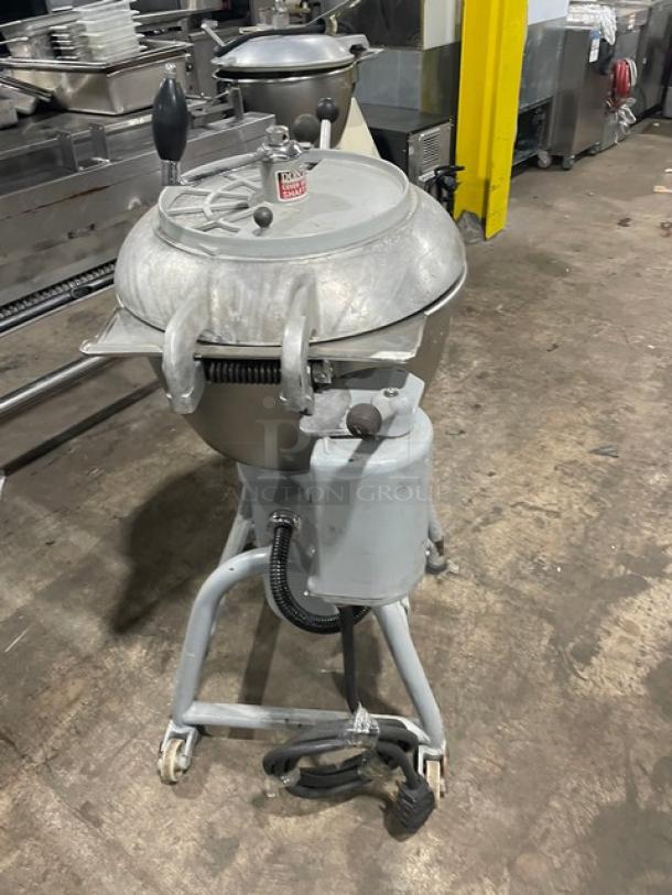Hobart commercial electric vertical chopper/mixer with stainless steel tilting bowl, cover, on legs and casters, in used condition.