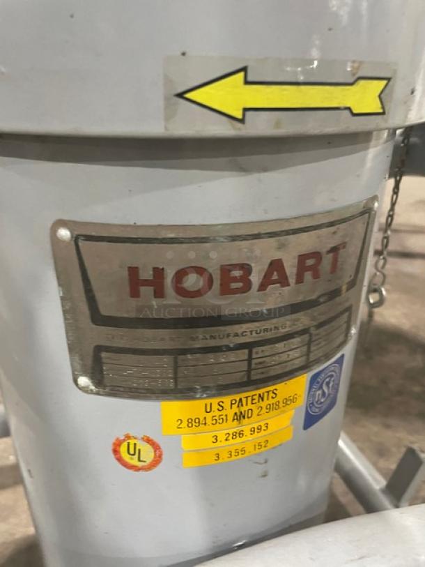Hobart commercial electric chopper/cutter with stainless steel tilting bowl and cover, on legs and casters, patent stickers visible.