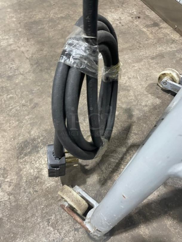 Hobart commercial electric cutter cable and base with caster, showing heavy-duty design and sturdy build for industrial use.