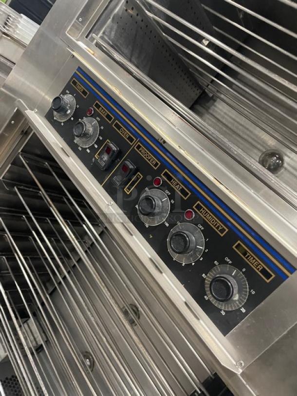 Nu-Vu SUB123 stainless steel double deck oven/proofer combo with control knobs, wired racks, and caster wheels. 208V, 3+N Phase.