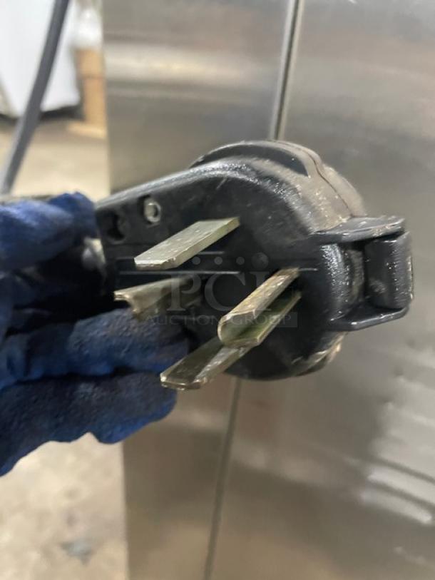 Close-up of 208V power plug for Nu-Vu SUB123 double deck oven/proofer, showing three prongs.