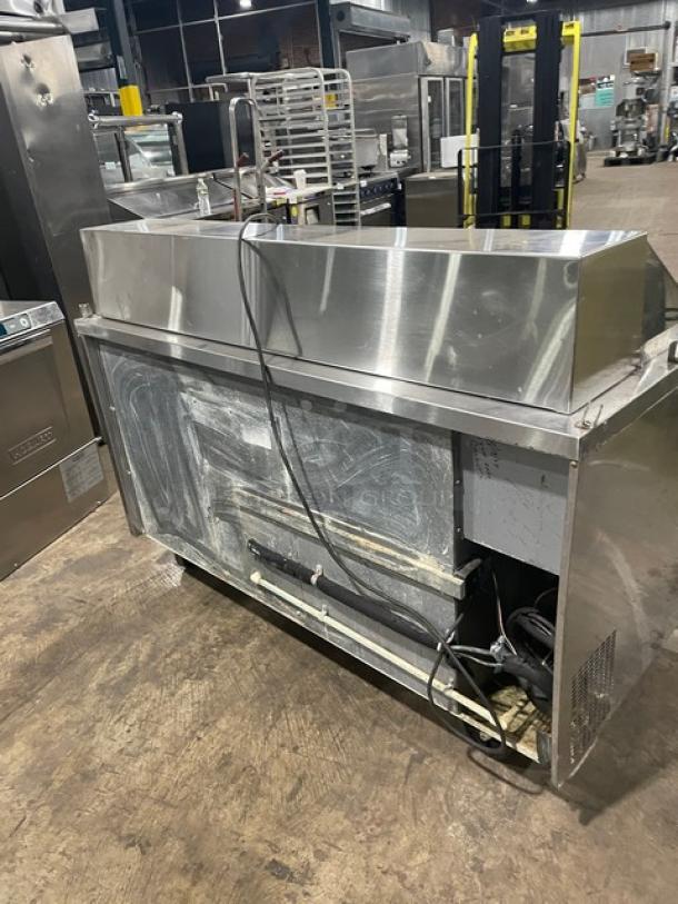 Randell Model 9040K7 stainless steel refrigerated prep table with two doors, poly-coated wire rack, on casters.