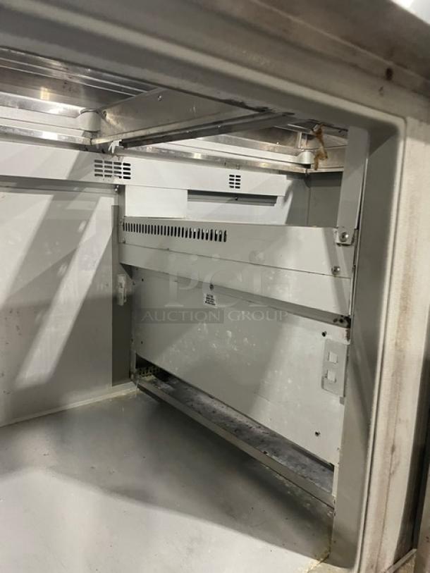 Randell Model 9040K7 refrigerated salad prep table interior, showing poly-coated wire rack and stainless steel finish.