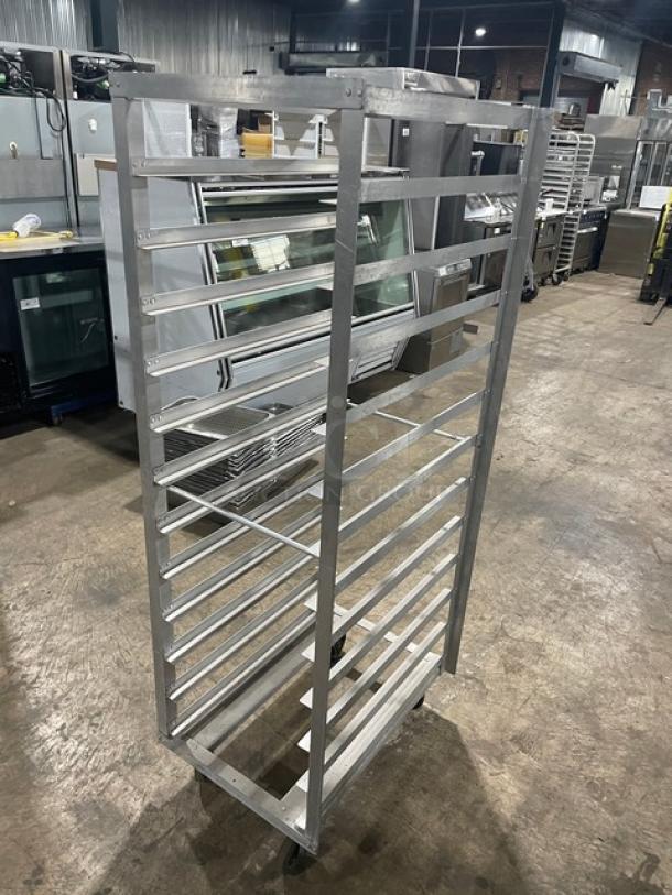 Commercial heavy-duty pan holding/transport rack on casters; aluminum construction; 15-slot capacity; excellent condition.