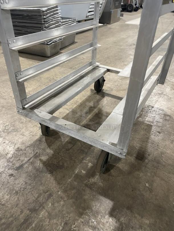 Commercial heavy-duty pan holding/transport rack with durable metal frame, on casters for easy mobility. Good condition.