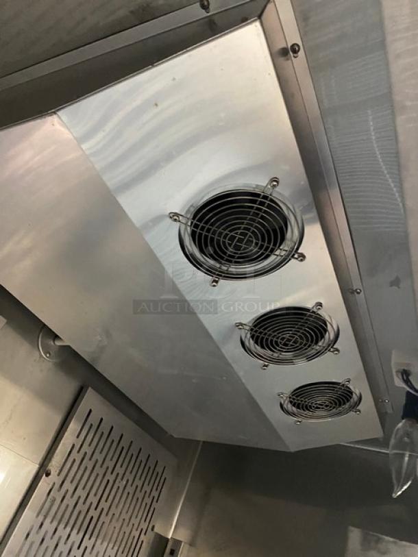 Kelvinator KCBM48R commercial stainless steel refrigerator interior, showing poly-coated wire racks and cooling fans.