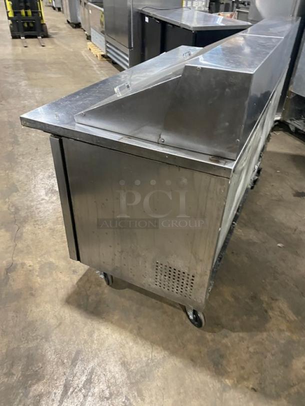 True commercial stainless steel 3-door refrigerated prep table, model TSSU-72-30M-B-ST, on casters, with poly-coated wire racks.