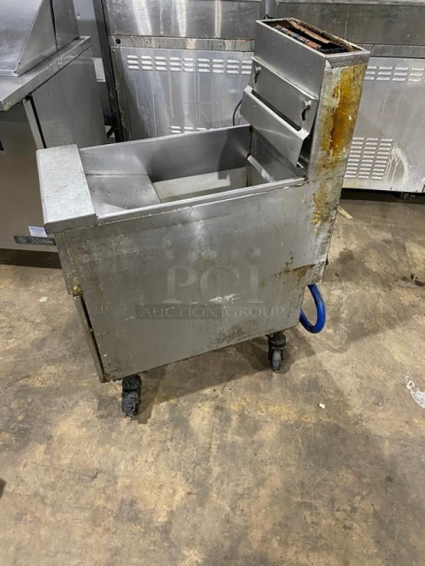 Pitco VF35 commercial stainless steel 35 lb. deep fat fryer with backsplash, basket hanger, blue gas connector hose, and casters.