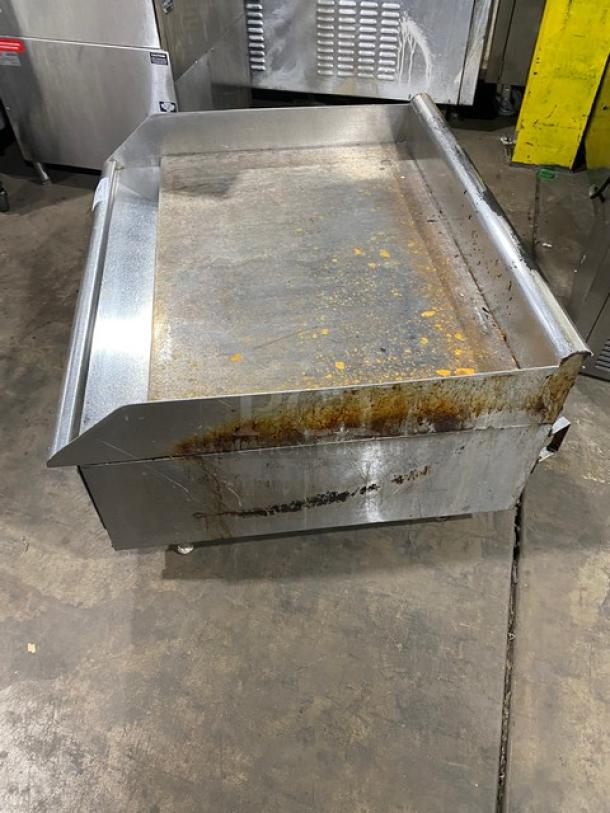 Southbend stainless steel natural gas countertop flat griddle with back and side splash, on legs, visible wear.