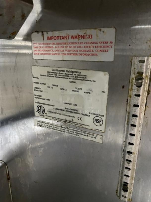 Continental commercial stainless steel 2-door refrigerated prep table with labels detailing power supply and maintenance info.