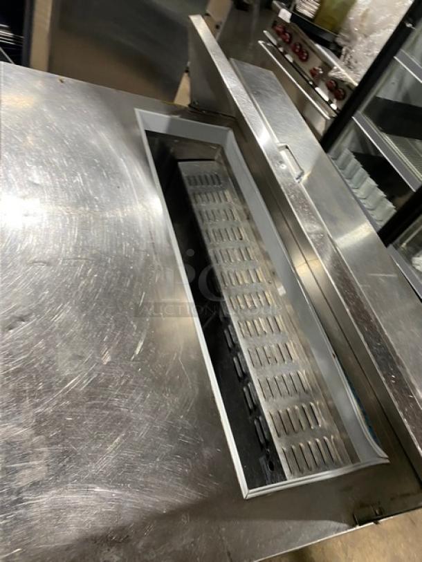 Continental stainless steel 2-door refrigerated Bain Marie style salad/sandwich prep table, 115V, on legs, with open lid.