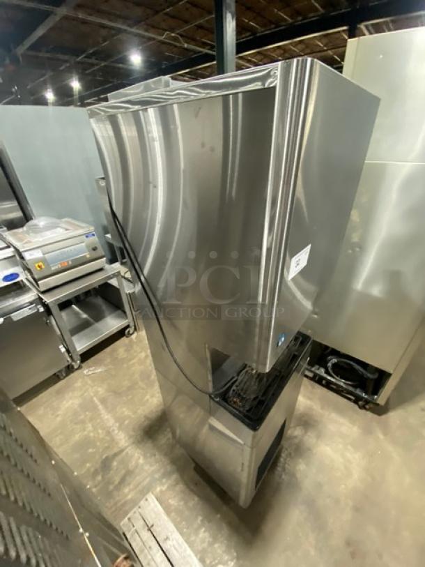 Hoshizaki DT-400BAH-OS commercial stainless steel ice maker and dispenser with water dispenser, model V10141J, on legs.