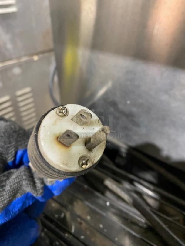 Close-up of plug for Hoshizaki DT-400BAH-OS ice and water dispenser, 3-prong, shows wear, compatible with 115-120V outlets.