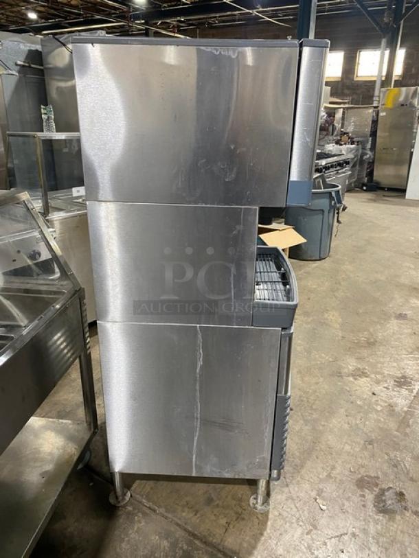 Follett Symphony Plus Series commercial ice and water dispenser, model 110FB425W, stainless steel, water-cooled, on legs.