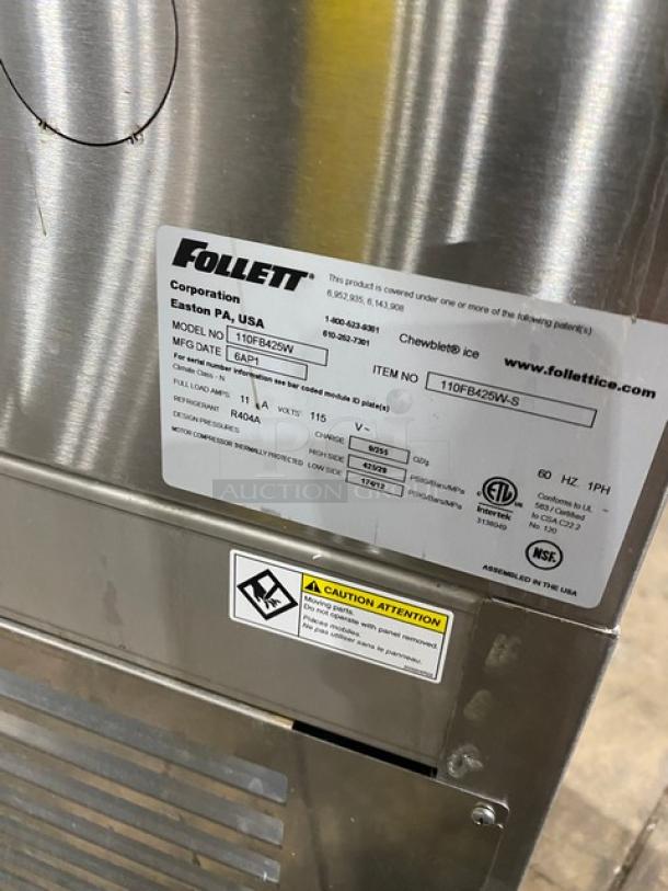 Follett Symphony Plus Series stainless steel ice maker, Model 110FB425W, 115V, 1 Phase, with water dispenser, on legs.