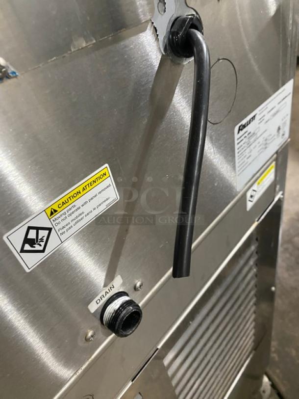 Follett Symphony Plus Series Ice Maker, Model 110FB425W, stainless steel, water-cooled, 115V, good condition, with caution labels.