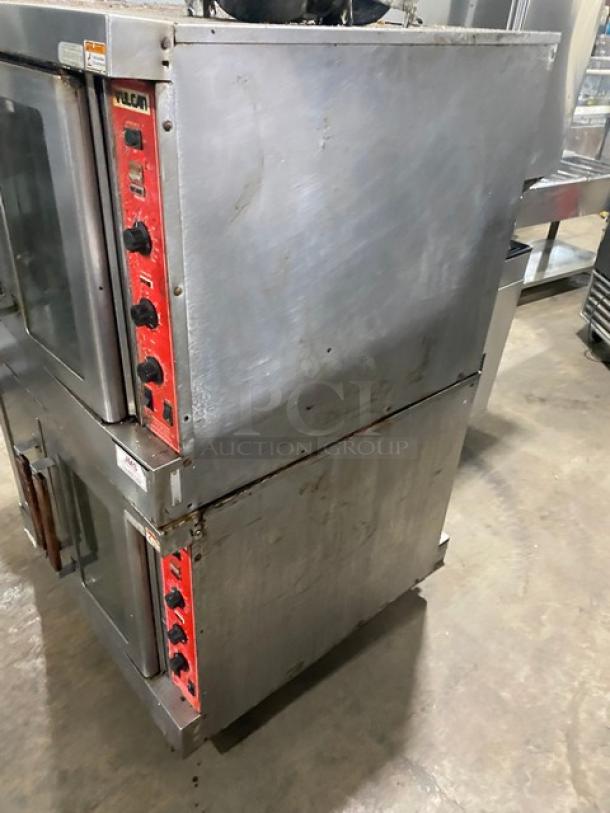 Vulcan commercial stainless steel double-stacked convection oven, natural gas, thermostatic controls, wired racks, on casters.