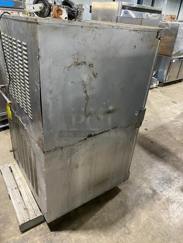 Vulcan commercial stainless steel double-stacked convection oven, natural gas, with thermostatic controls, wired racks, on casters, visible wear.