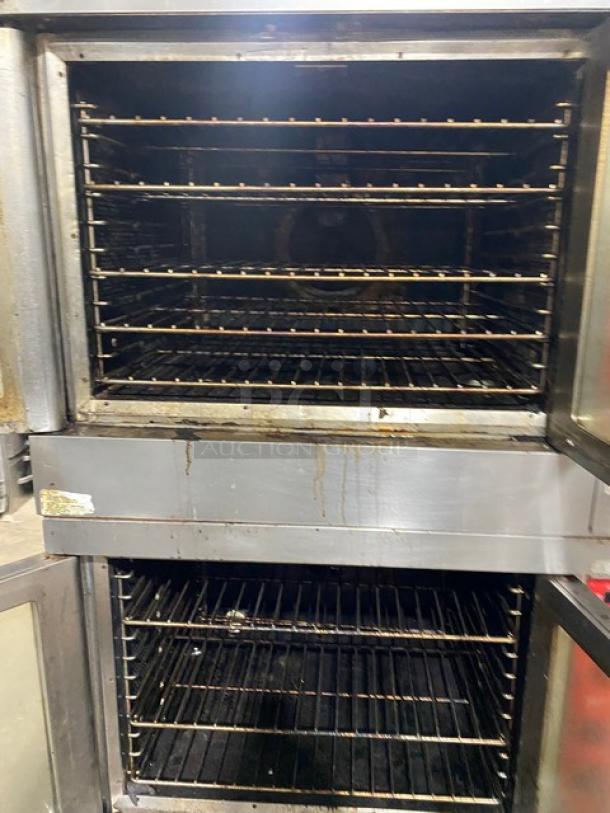 Vulcan commercial stainless steel double stacked convection oven, natural gas, with thermostatic controls, wired racks, and casters.