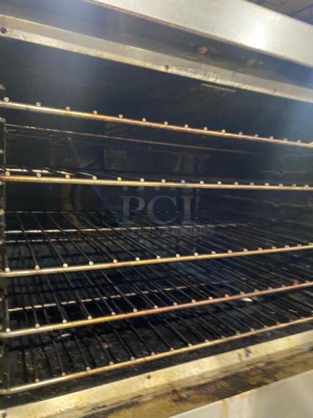 Vulcan commercial stainless steel convection oven, double-stacked, natural gas-powered, with thermostatic controls and wired racks.