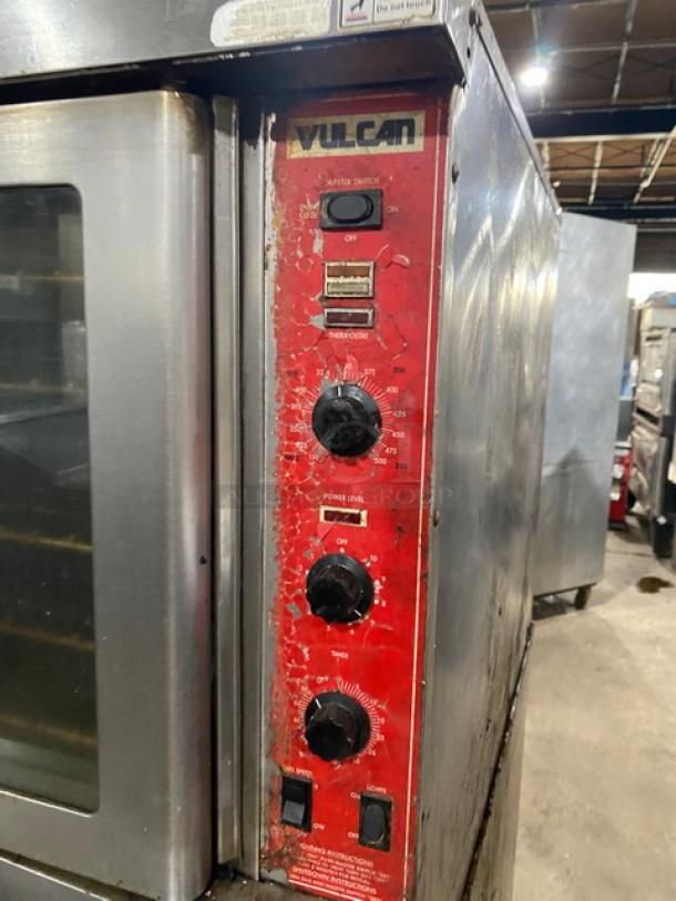Vulcan commercial stainless steel double stacked convection oven with thermostatic controls and wired racks, on casters.