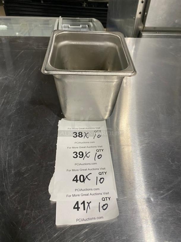 Commercial stainless steel steamtable pan, rectangular, pristine condition, on a metal surface with auction tags.