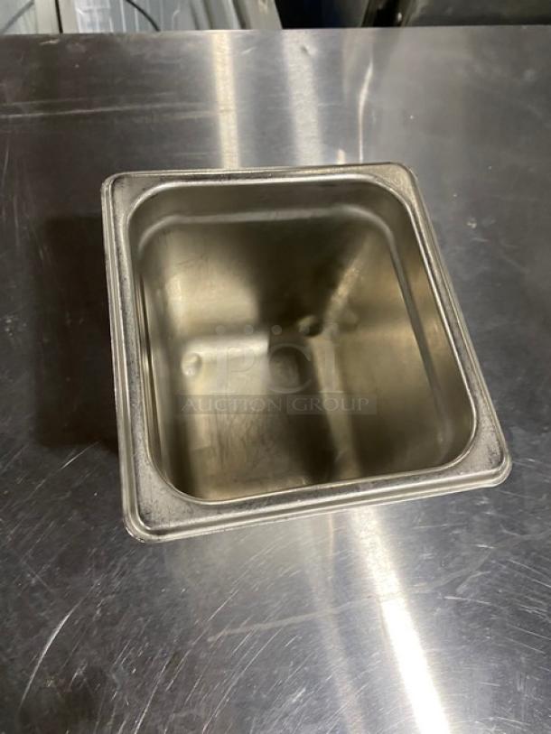 Commercial stainless steel steamtable pan, rectangular shape, good condition, visible scratches on interior surface.