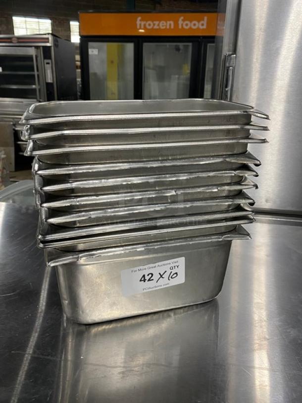 Stack of commercial stainless steel hotel steamtable pans, good condition. Label reads "42 Qty." Ideal for catering.