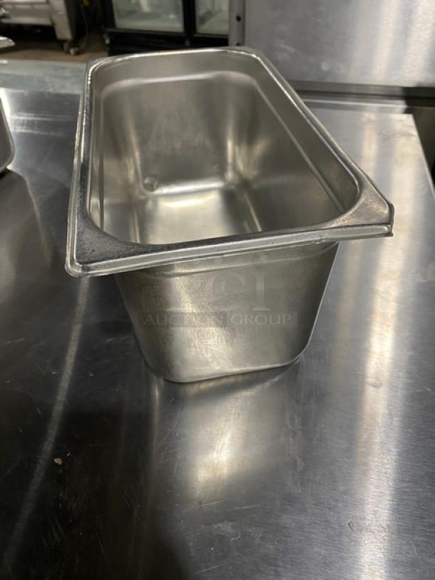 Stainless steel steamtable pan, commercial grade, in excellent condition, dimensions unknown, reflective finish.