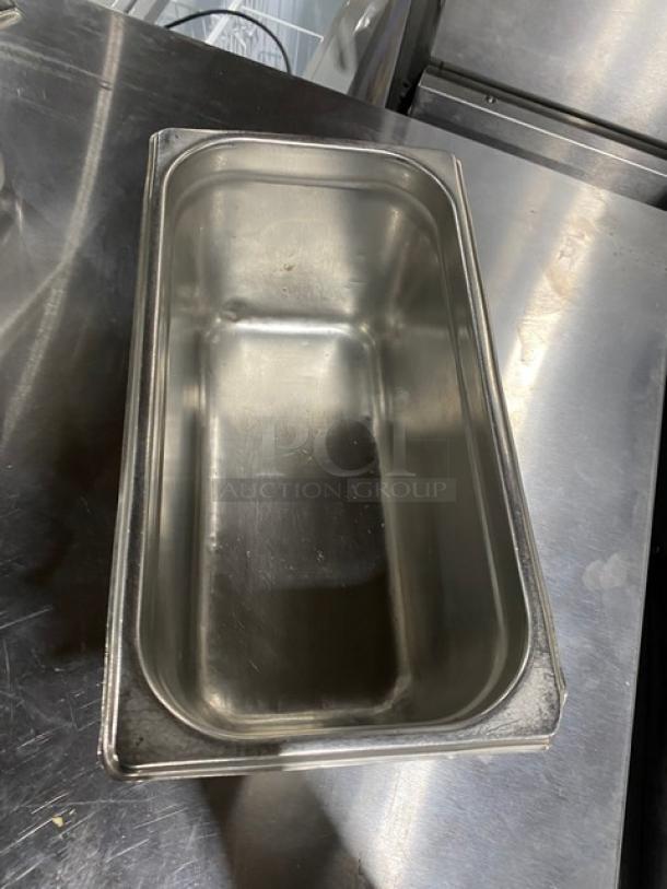 Stainless steel hotel steamtable pan, rectangular, commercial grade, used condition, smooth finish, durable construction.