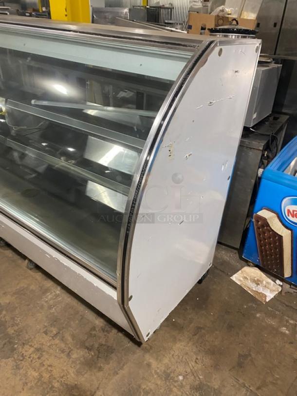 Leader NRHD96R Stainless Steel 96" refrigerated display case with curved glass, rear sliding doors, and lower storage.