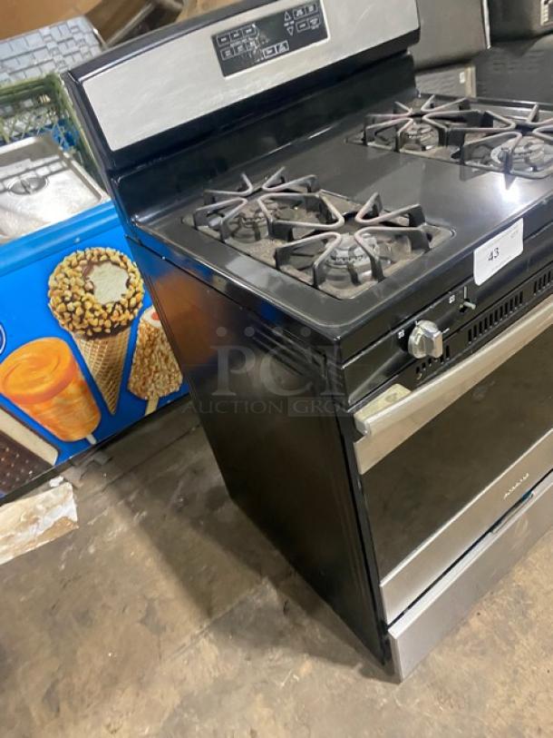 Amana stainless steel/black natural gas 4-burner range/oven combo with digital controls and wired oven rack.