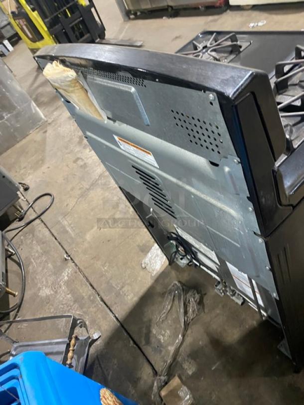 Amana commercial 4-burner gas range/oven, stainless steel/black, digital controls, wired oven rack, visible back panel.