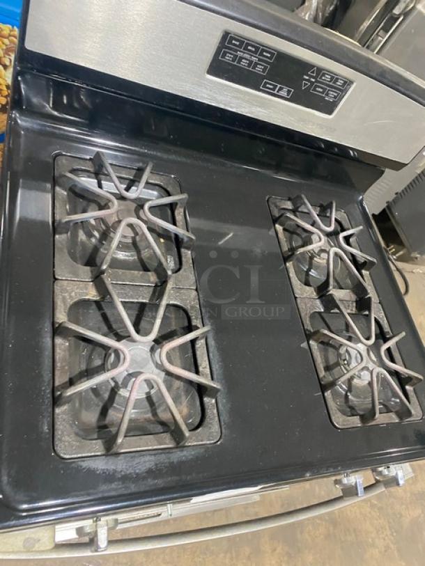 Amana commercial stainless steel/black 4-burner gas range with digital controls and wired oven rack. Natural gas powered.