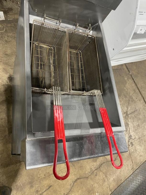 Cookline commercial stainless steel deep fat fryer with back splash, basket hanger, and red-handled fry baskets. On legs.
