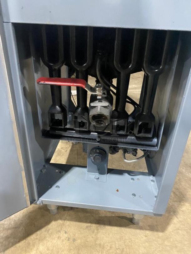 Cookline stainless steel natural gas fryer with back splash, basket hanger, fry baskets, and sturdy legs. Excellent condition.