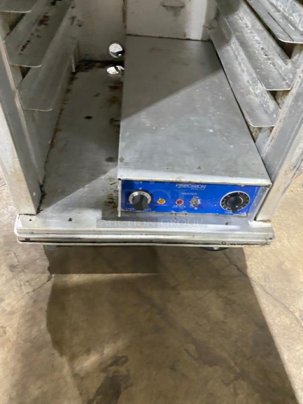 Precision full-height heated holding/proofing cabinet with built-in pan slides, electric powered, on casters, some wear visible.