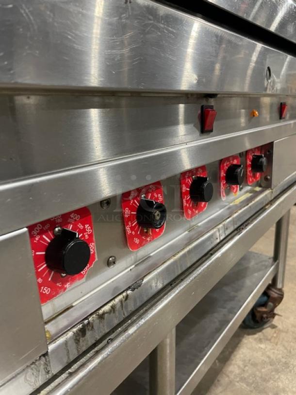 Stainless steel gas griddle with thermostatic controls, back and side splash, undershelf stand, and casters.